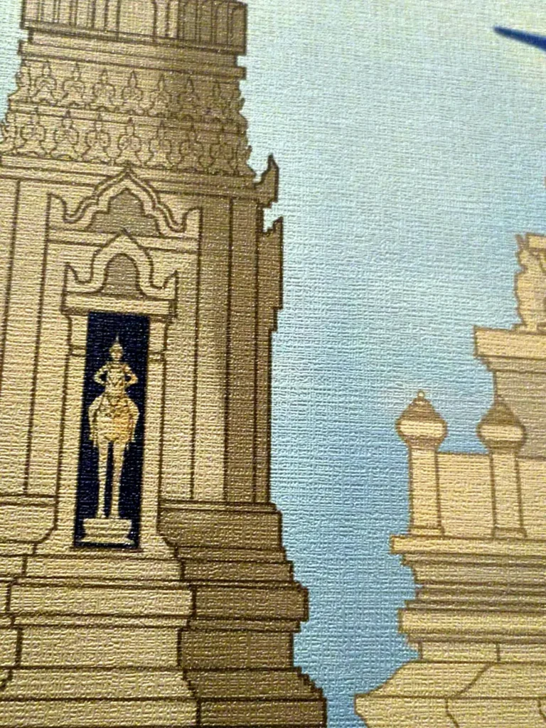 Close-up of a printed wall mural showing Thai temple artwork on textured wallcovering